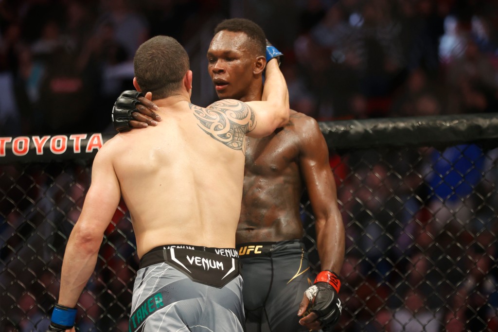 Israel Adesanya and Robert Whittaker exchanging words after their fight at UFC 271